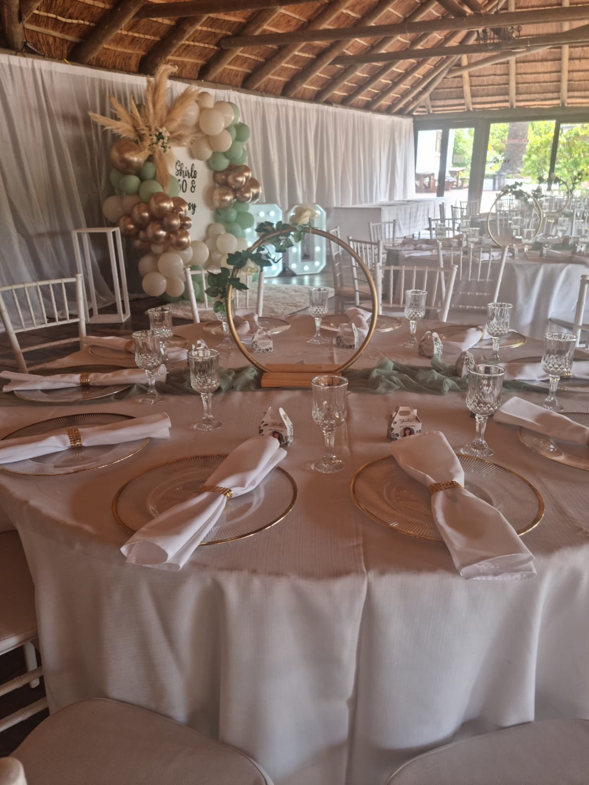 Thatch roof beams draped with white fabric